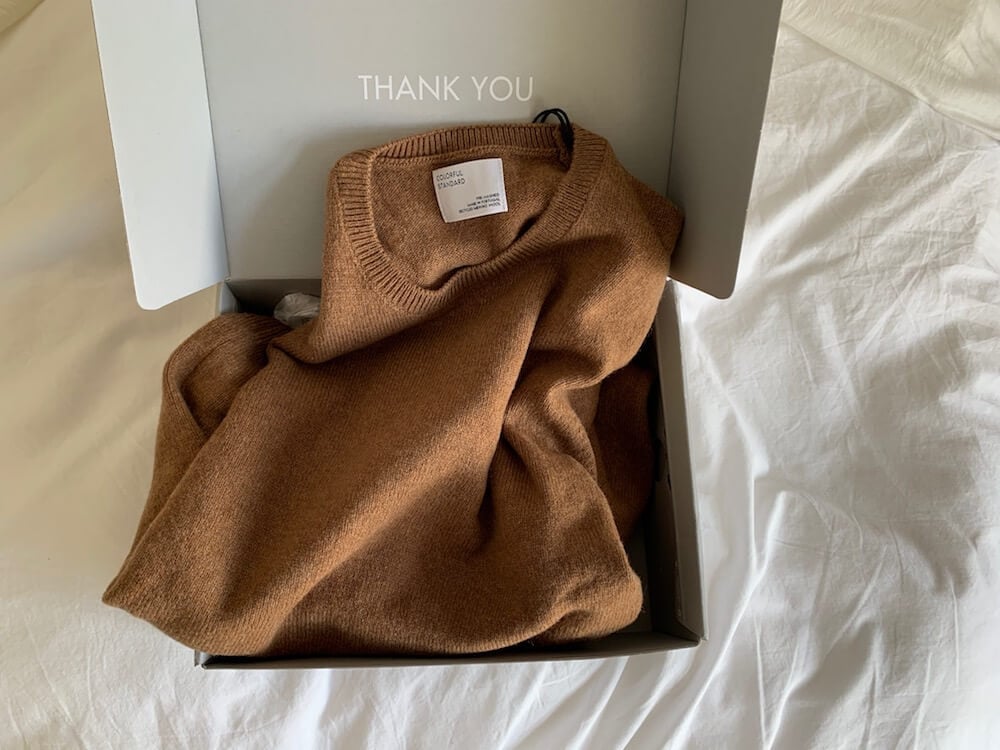 Colorful Standard Recycled merino wool sweater in sahara brown pictured in box