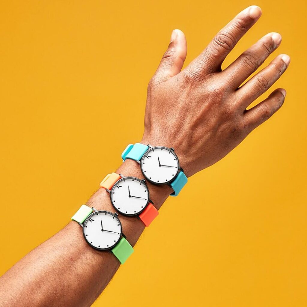 Image showing a wrist with three Ksana watches, made from vegan materials