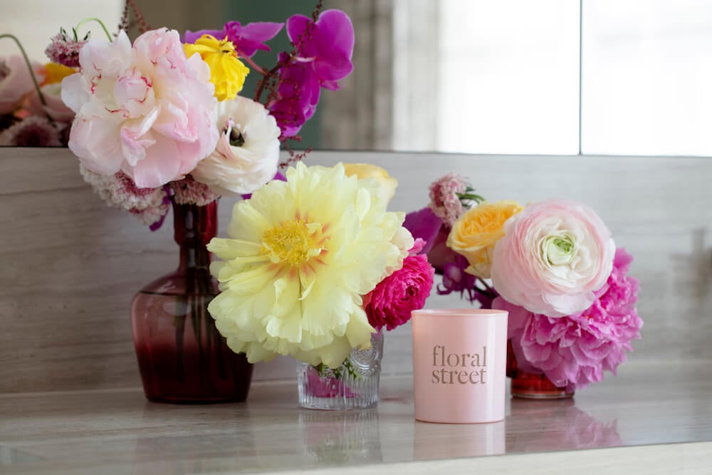 Floral Street candle pictured with flowers