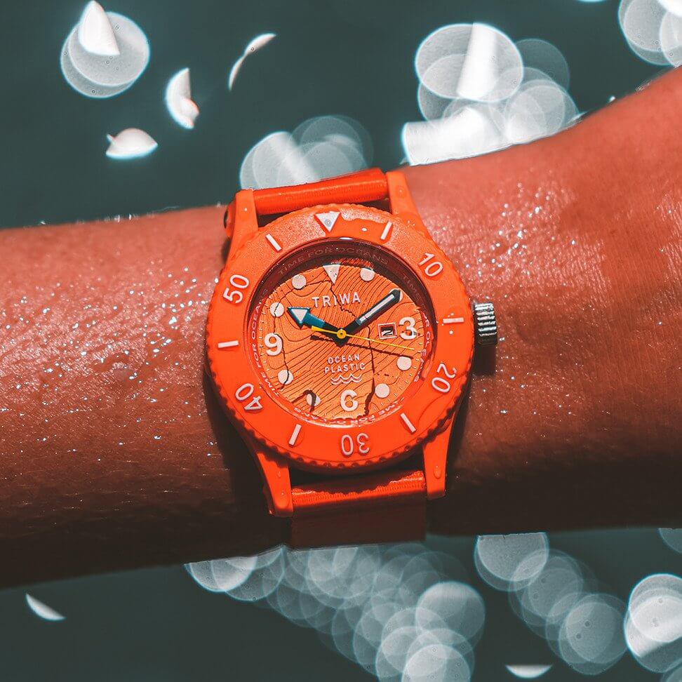 TRIWA orange ocean watch made from recycled ocean plastic shown on wrist