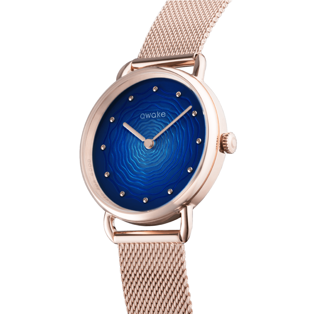 This image features an Awake concept eco friendly watch with recycled steel, this watch is rose gold with a blue watch face