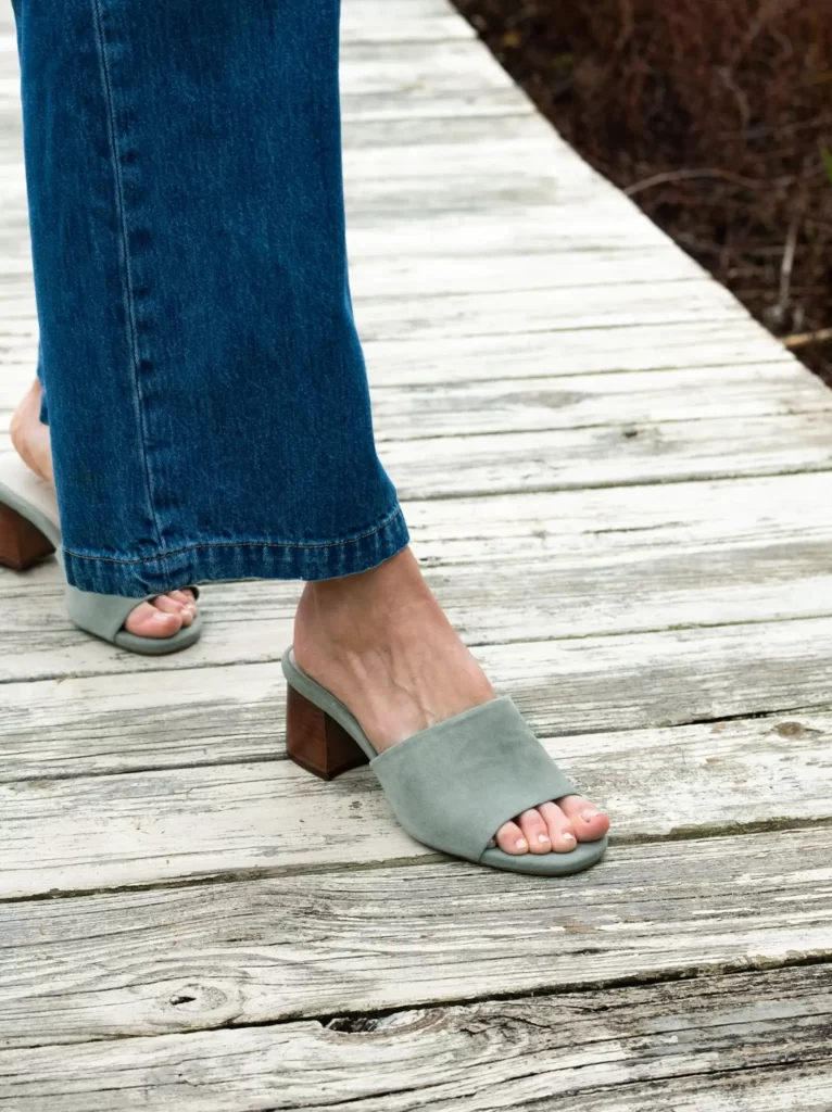 Model wears jeans and Able sustainable mules