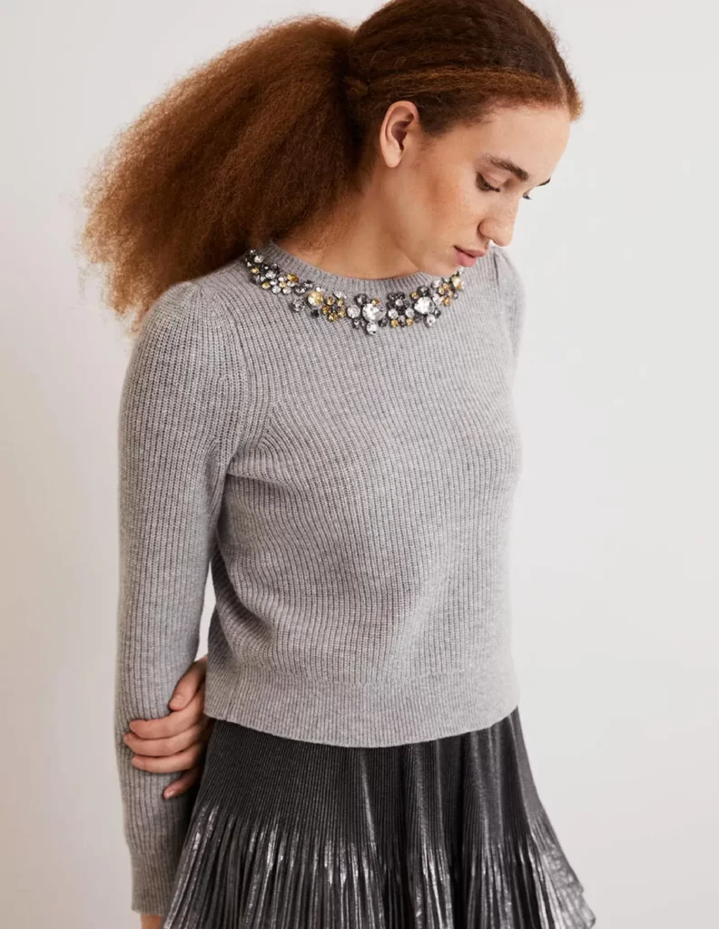 Model wears grey jumper form UK sustainable clothing brand Boden