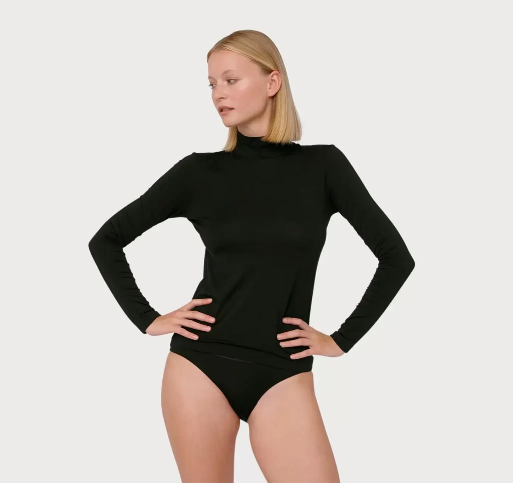 Model wears black turtleneck sustainable